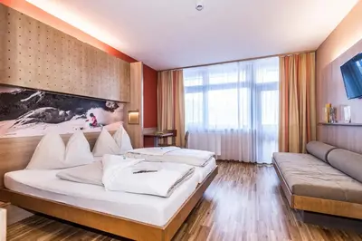 Ein Bett oder Betten in einem Zimmer der Unterkunft JUFA Hotel Altenmarkt-Zauchensee