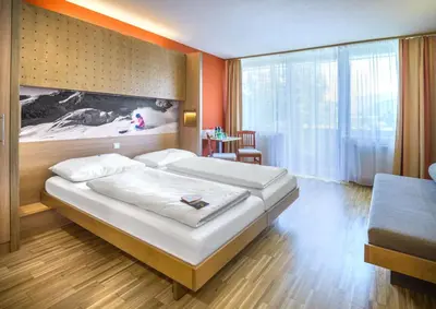 Ein Bett oder Betten in einem Zimmer der Unterkunft JUFA Hotel Altenmarkt-Zauchensee