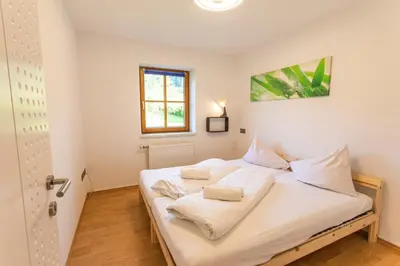Ein Bett oder Betten in einem Zimmer der Unterkunft Sunshine Aich by Alpenidyll Apartments