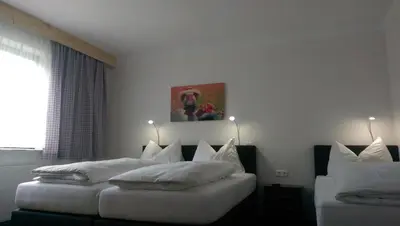 Ein Bett oder Betten in einem Zimmer der Unterkunft Gästehaus Zum Steirischen Kuss