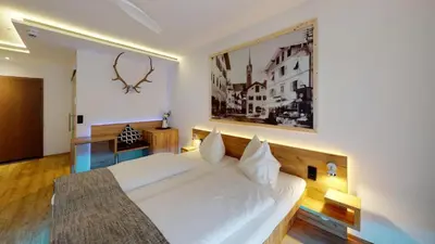 Ein Bett oder Betten in einem Zimmer der Unterkunft Boutique Hotel Adler