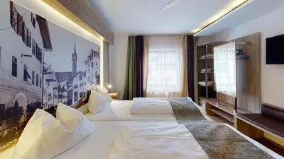 Ein Bett oder Betten in einem Zimmer der Unterkunft Boutique Hotel Adler