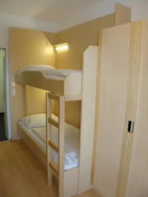 Ein Bett oder Betten in einem Zimmer der Unterkunft Jugendgästehaus St. Gilgen