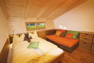 Ein Bett oder Betten in einem Zimmer der Unterkunft Alpin Chalet Kleinarl