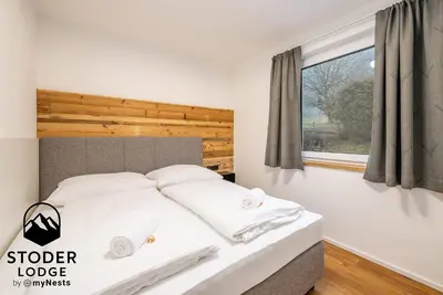Ein Bett oder Betten in einem Zimmer der Unterkunft StoderLodge - Alpine Garden Residence - by myNests