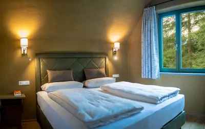 Ein Bett oder Betten in einem Zimmer der Unterkunft Villa Bergzauber
