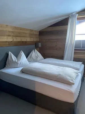 Ein Bett oder Betten in einem Zimmer der Unterkunft Dr. Aufmesser Appartements