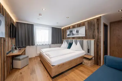 Ein Bett oder Betten in einem Zimmer der Unterkunft Austria Alpinhotel Ski IN Ski OUT an der Edelweissbahn