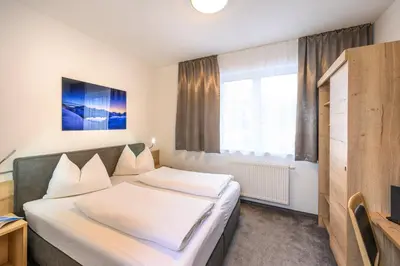 Ein Bett oder Betten in einem Zimmer der Unterkunft Appartements Insieme