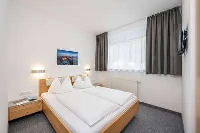 Ein Bett oder Betten in einem Zimmer der Unterkunft Appartements Insieme