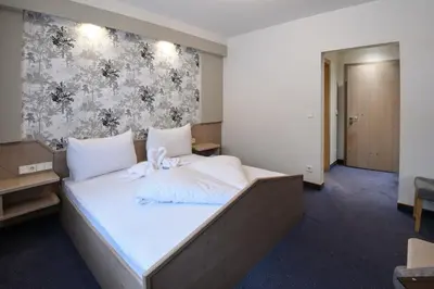 Ein Bett oder Betten in einem Zimmer der Unterkunft Golf & Skipension Krug