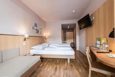Ein Bett oder Betten in einem Zimmer der Unterkunft JUFA Hotel Grundlsee