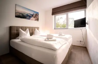 Ein Bett oder Betten in einem Zimmer der Unterkunft Tauernresidence Radstadt by ALPS RESORTS