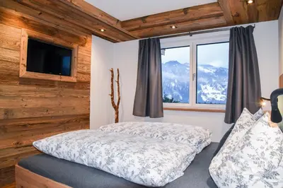 Ein Bett oder Betten in einem Zimmer der Unterkunft Alpendorf Auszeit
