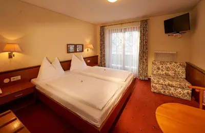 Ein Bett oder Betten in einem Zimmer der Unterkunft Wohlfühlresort und Feriengut Martinerhof