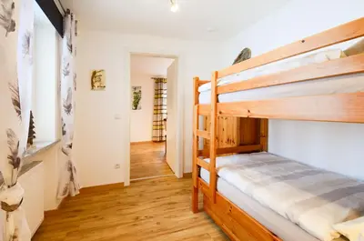 Ein Bett oder Betten in einem Zimmer der Unterkunft Apartmenthaus Vergissmeinnicht