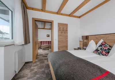 Ein Bett oder Betten in einem Zimmer der Unterkunft Apartments & Garni Alpenrose