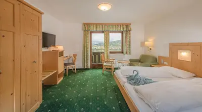 Ein Bett oder Betten in einem Zimmer der Unterkunft Hotel Berghof