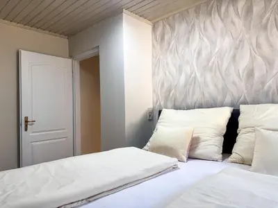 Ein Bett oder Betten in einem Zimmer der Unterkunft White Pearl Apartment