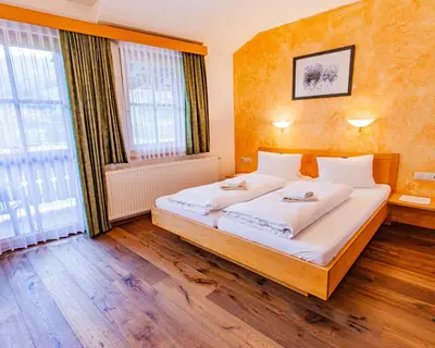 Ein Bett oder Betten in einem Zimmer der Unterkunft Gästehaus Hartweger