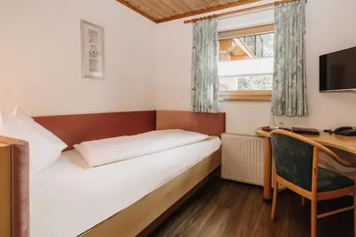 Ein Bett oder Betten in einem Zimmer der Unterkunft Hotel Garni Tannenhof