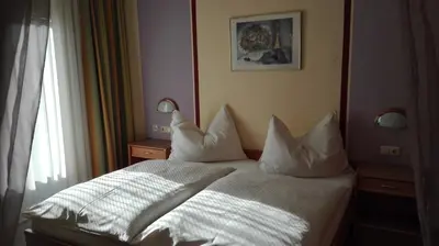 Ein Bett oder Betten in einem Zimmer der Unterkunft Pension Restaurant Meran
