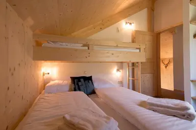 Ein Bett oder Betten in einem Zimmer der Unterkunft Hirsch Chalet
