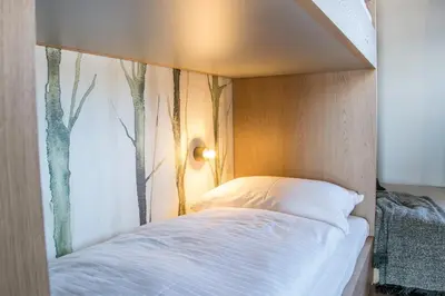 Ein Bett oder Betten in einem Zimmer der Unterkunft KAUZ - Design Chalets inkl Lungau Card
