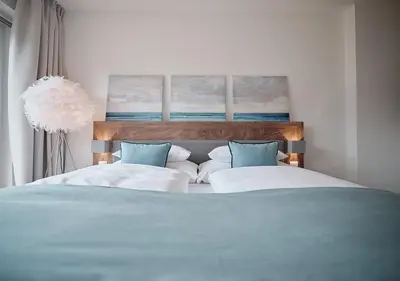 Ein Bett oder Betten in einem Zimmer der Unterkunft SEE Moment Appartements ADULTS ONLY