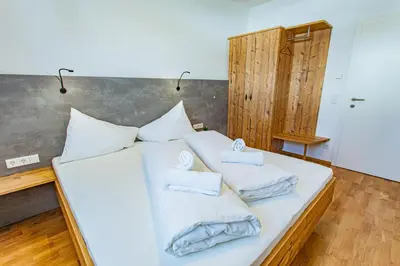 Ein Bett oder Betten in einem Zimmer der Unterkunft Happy Aich 2 by Alpenidyll Apartments