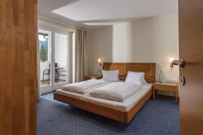 Ein Bett oder Betten in einem Zimmer der Unterkunft Aparthotel Tritscher