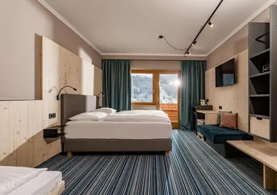 Ein Bett oder Betten in einem Zimmer der Unterkunft Ferienalm Panorama Hotel