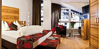 Ein Bett oder Betten in einem Zimmer der Unterkunft Sporthotel Snowwhite