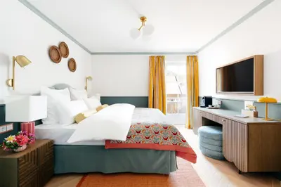 Ein Bett oder Betten in einem Zimmer der Unterkunft Villa Alma - a lakeside Boutique Hotel