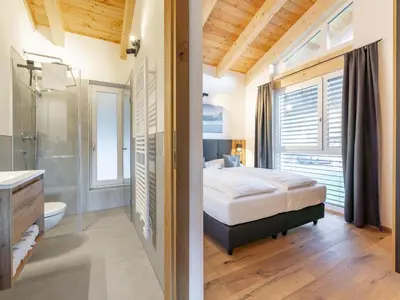 Ein Bett oder Betten in einem Zimmer der Unterkunft Grebenzen Lodge Hirsch